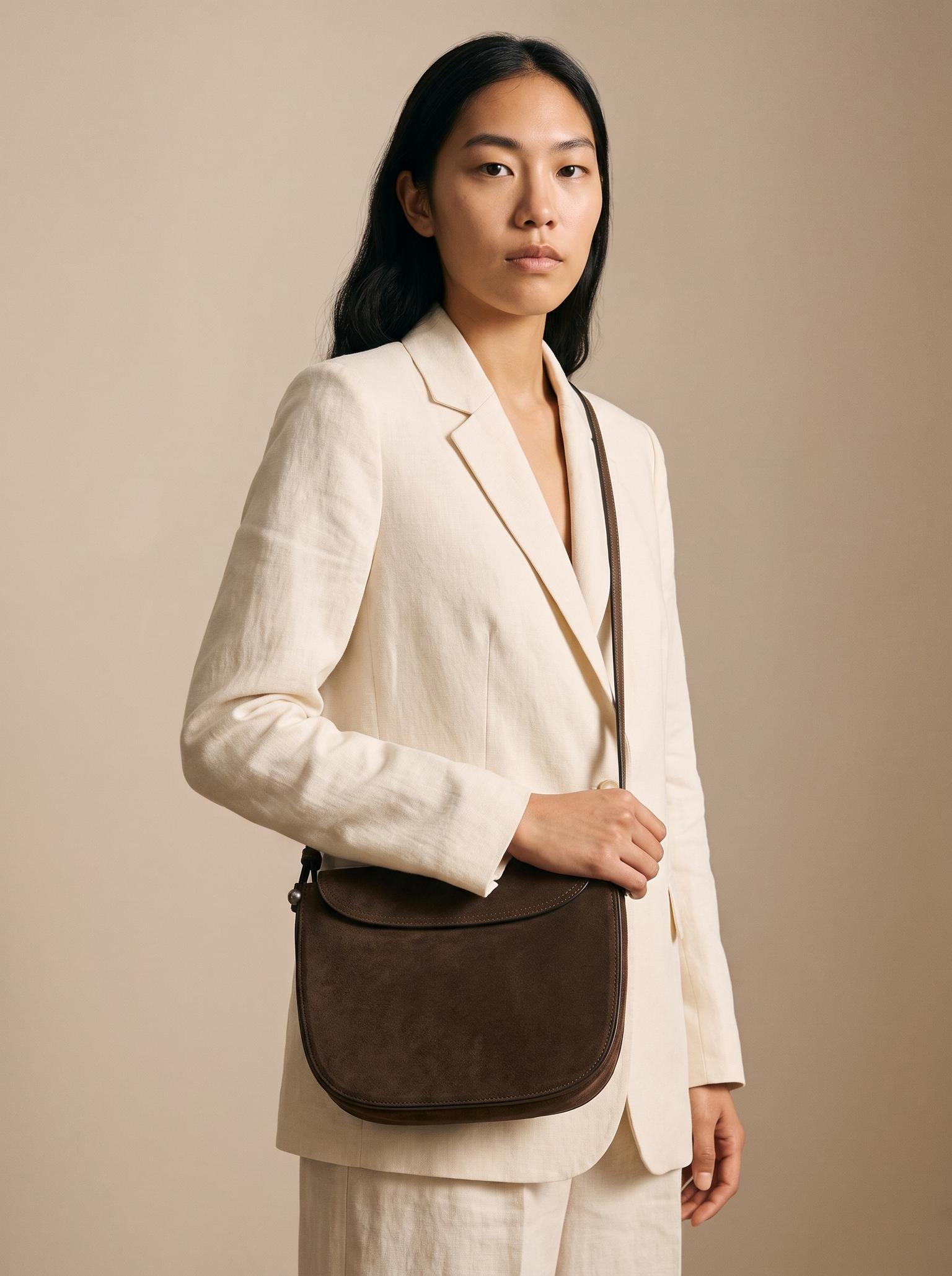 Campaign image of the same model wearing the uploaded handbag